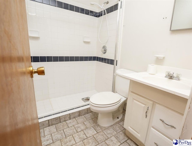 bathroom featuring vanity, a baseboard heating unit, toilet, and tiled shower