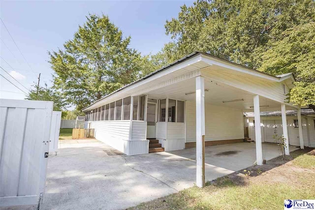 exterior space with a carport and a sunroom