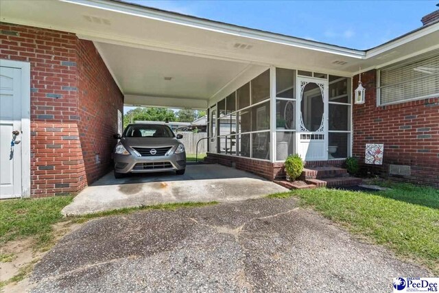 2338 W Mccown Dr, Florence, SC 29501 - view of vehicle parking featuring asphalt driveway and a carport