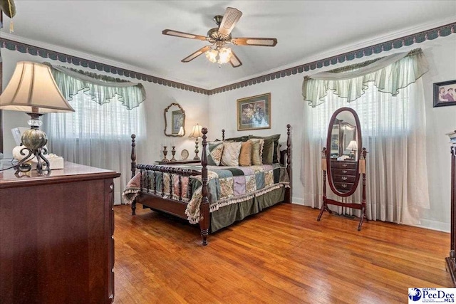 2338 W Mccown Dr, Florence, SC 29501 - bedroom with wood finished floors, crown molding, and a ceiling fan