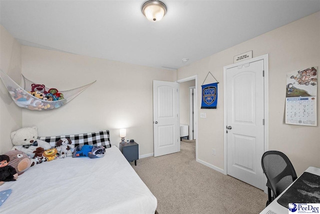 bedroom with baseboards and carpet