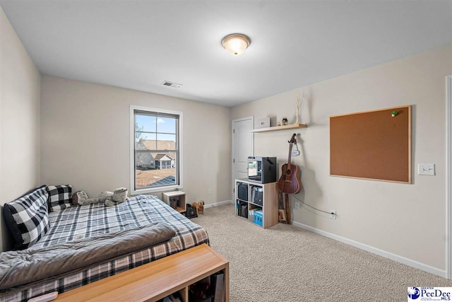 carpeted bedroom with baseboards and visible vents