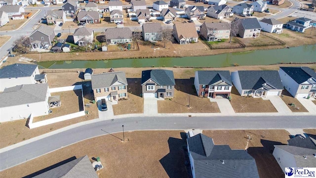 birds eye view of property featuring a water view and a residential view