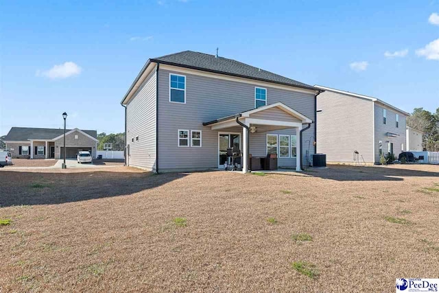 rear view of house featuring a patio area and cooling unit