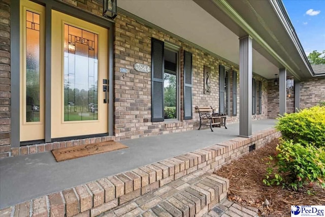 3844 W Lake Dr, Florence, SC 29501 - doorway to property with a porch and brick siding