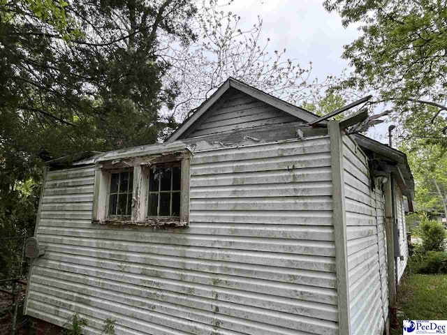 view of side of property featuring an outbuilding