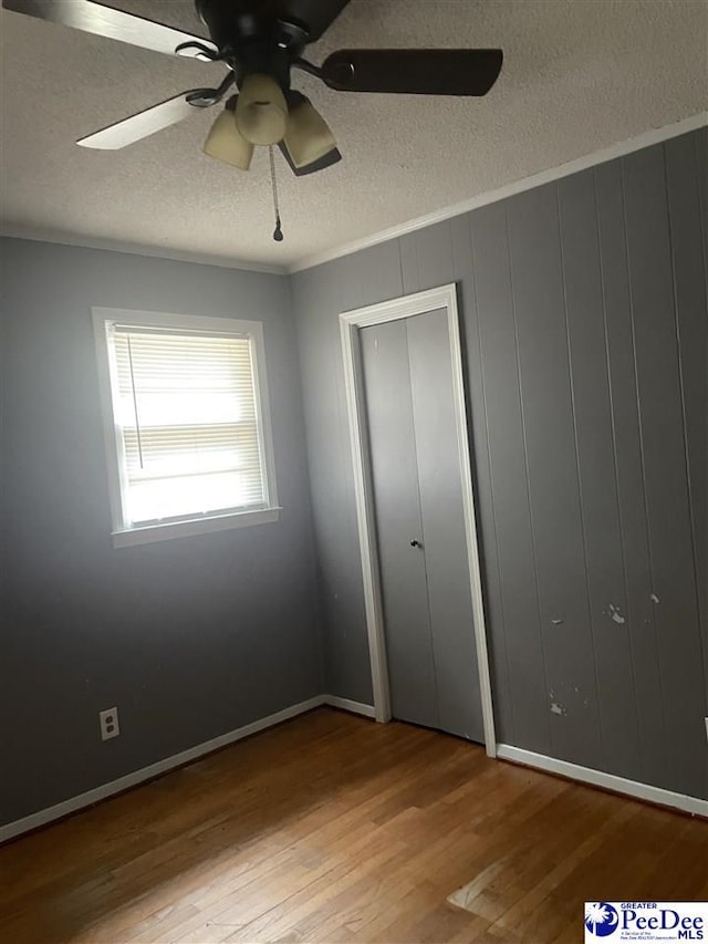 108 Swails St, Kingstree, SC 29556 - unfurnished bedroom featuring a textured ceiling, wood finished floors, crown molding, and ceiling fan