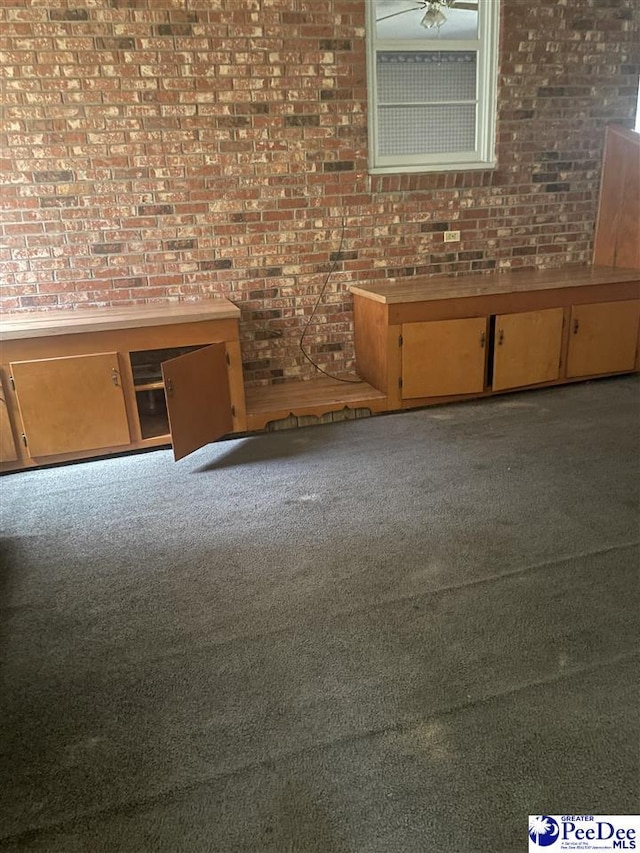 108 Swails St, Kingstree, SC 29556 - unfurnished living room with brick wall and carpet floors