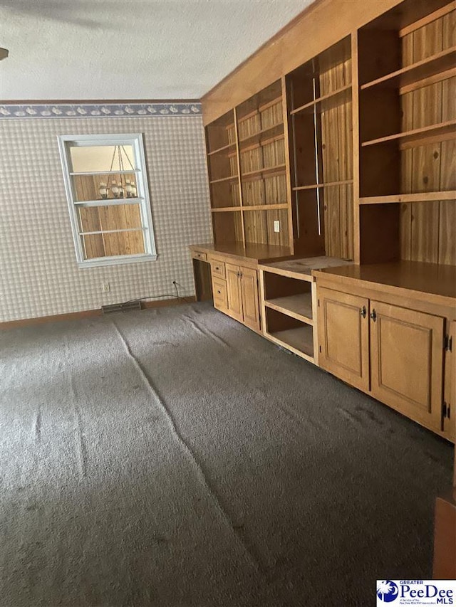 108 Swails St, Kingstree, SC 29556 - unfurnished living room with carpet, wallpapered walls, and a textured ceiling