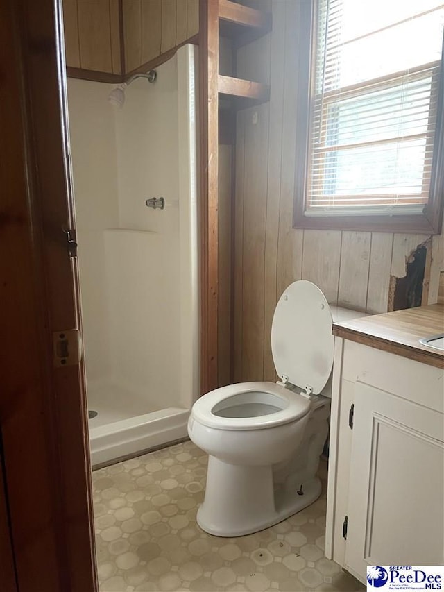108 Swails St, Kingstree, SC 29556 - full bathroom with vanity, a stall shower, toilet, tile patterned floors, and wooden walls