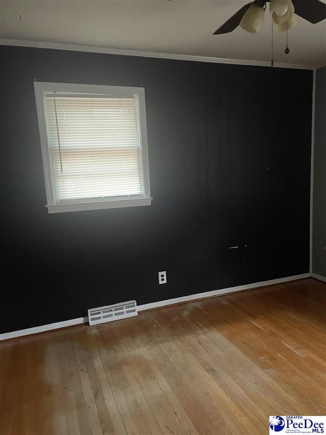 108 Swails St, Kingstree, SC 29556 - unfurnished room featuring a ceiling fan, wood-type flooring, ornamental molding, and baseboards