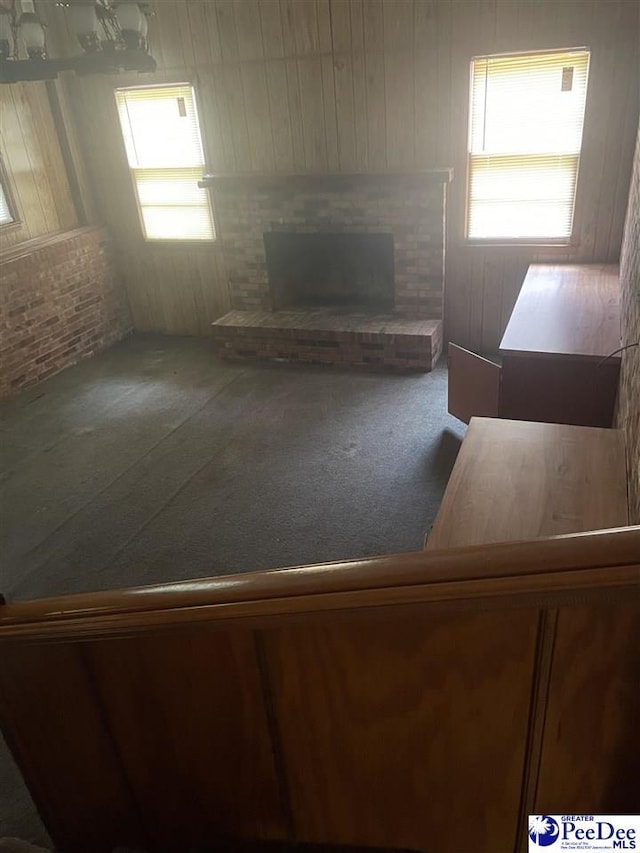 108 Swails St, Kingstree, SC 29556 - unfurnished living room featuring a fireplace, carpet flooring, and wooden walls