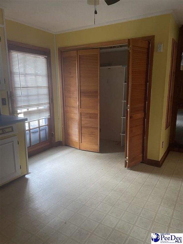 108 Swails St, Kingstree, SC 29556 - unfurnished bedroom featuring light flooring, a closet, crown molding, baseboards, and ceiling fan