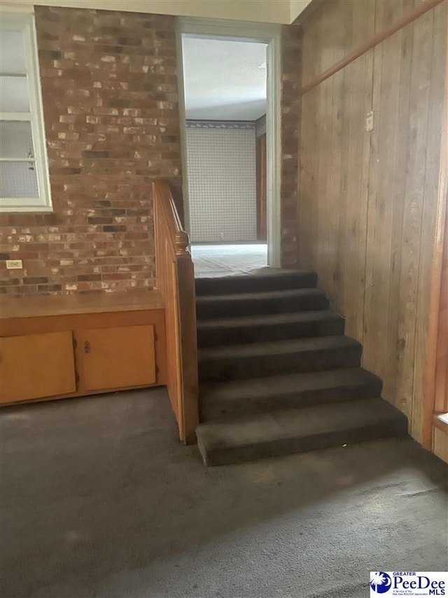 108 Swails St, Kingstree, SC 29556 - staircase with carpet, brick wall, and wooden walls