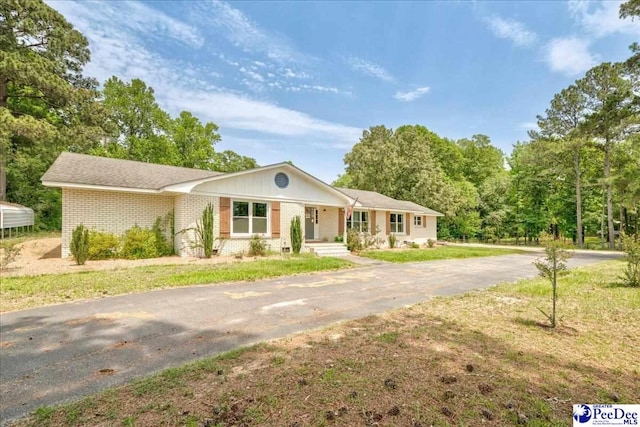 133 Peacock Row, Lamar, SC 29069 - single story home with asphalt driveway, a front yard, and brick siding