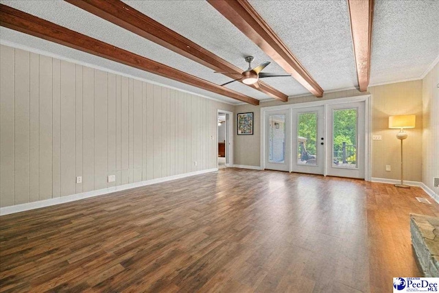 133 Peacock Row, Lamar, SC 29069 - unfurnished living room with beamed ceiling, a ceiling fan, wood finished floors, baseboards, and a textured ceiling