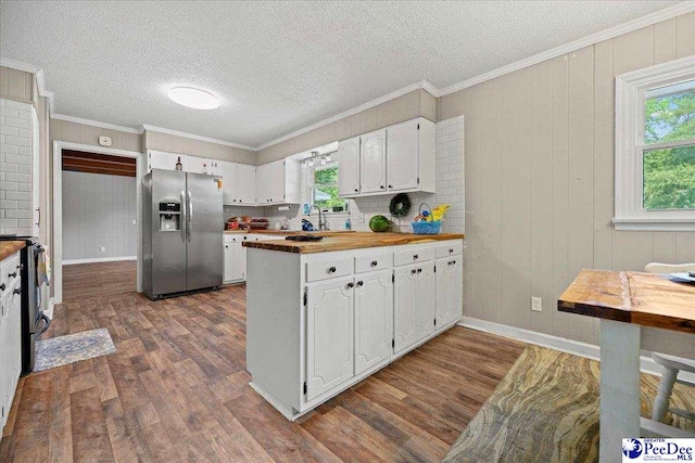 133 Peacock Row, Lamar, SC 29069 - kitchen featuring stainless steel fridge with ice dispenser, dark wood-style flooring, plenty of natural light, ornamental molding, and a textured ceiling