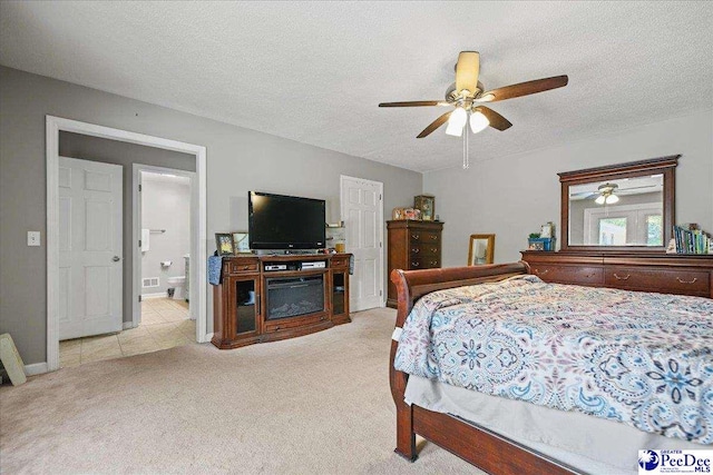 133 Peacock Row, Lamar, SC 29069 - bedroom with carpet, a textured ceiling, ceiling fan, and ensuite bathroom
