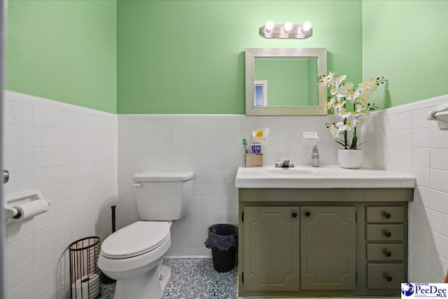 133 Peacock Row, Lamar, SC 29069 - bathroom featuring tile walls, vanity, toilet, a wainscoted wall, and tile patterned flooring