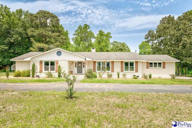 133 Peacock Row, Lamar, SC 29069 - ranch-style house featuring a front yard, brick siding, a chimney, and driveway