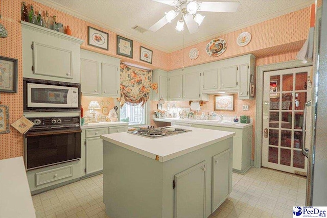 kitchen with a center island, green cabinets, black oven, stainless steel gas stovetop, and white microwave