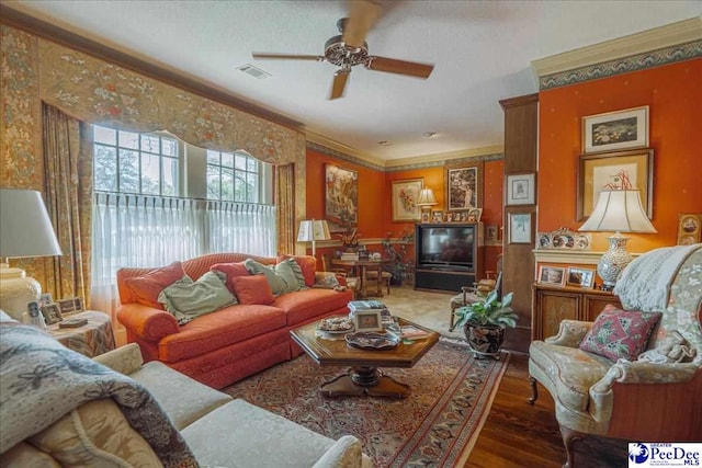 living room featuring ornamental molding, ceiling fan, and dark hardwood / wood-style flooring