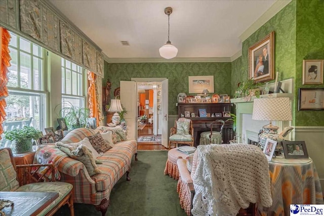 living area featuring crown molding