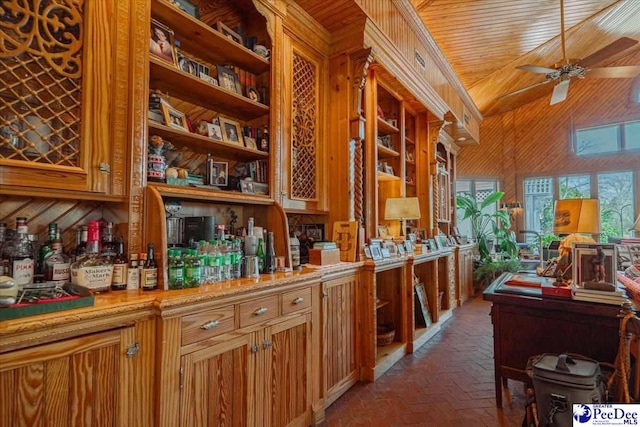 bar featuring ceiling fan, wooden walls, vaulted ceiling, and wooden ceiling