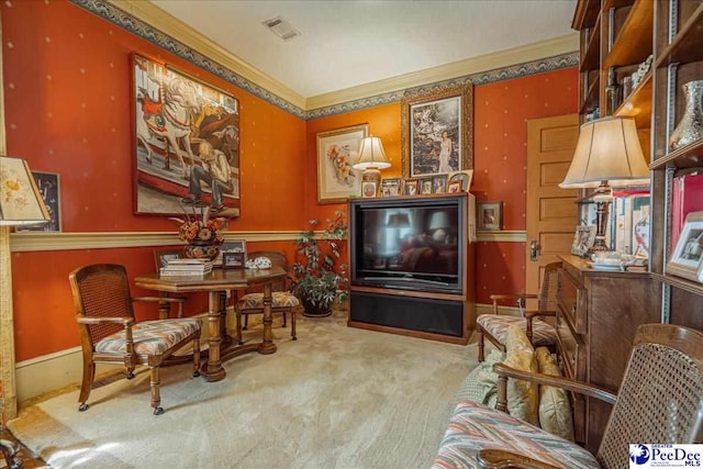 living area with crown molding and carpet