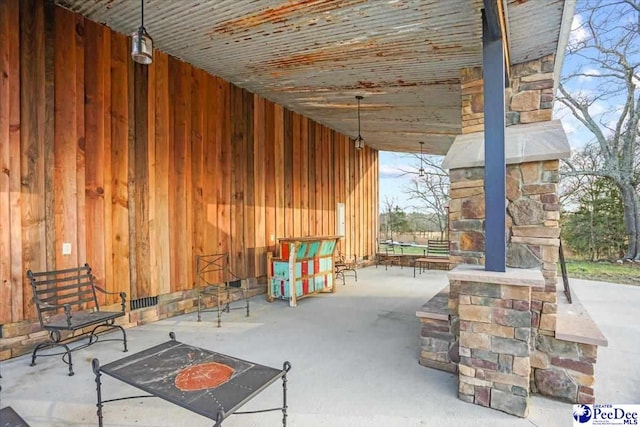 view of patio with an outdoor fireplace
