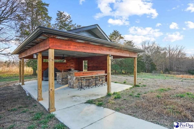 view of patio / terrace with outdoor dry bar and area for grilling