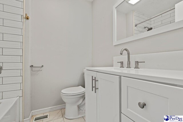 bathroom featuring visible vents, baseboards, toilet, shower / tub combination, and vanity