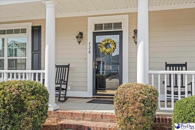 entrance to property featuring covered porch