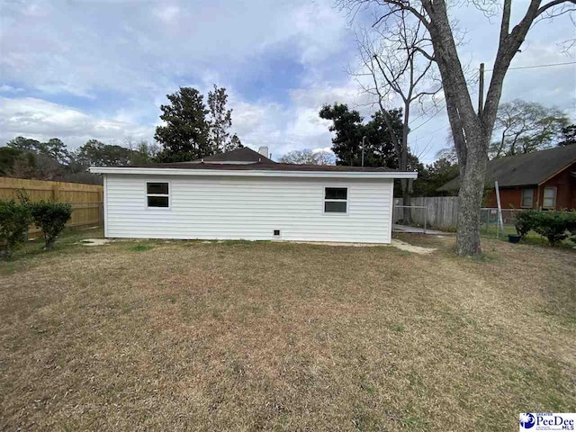 exterior space with fence and a yard