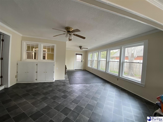 interior space featuring a ceiling fan, crown molding, and a textured ceiling