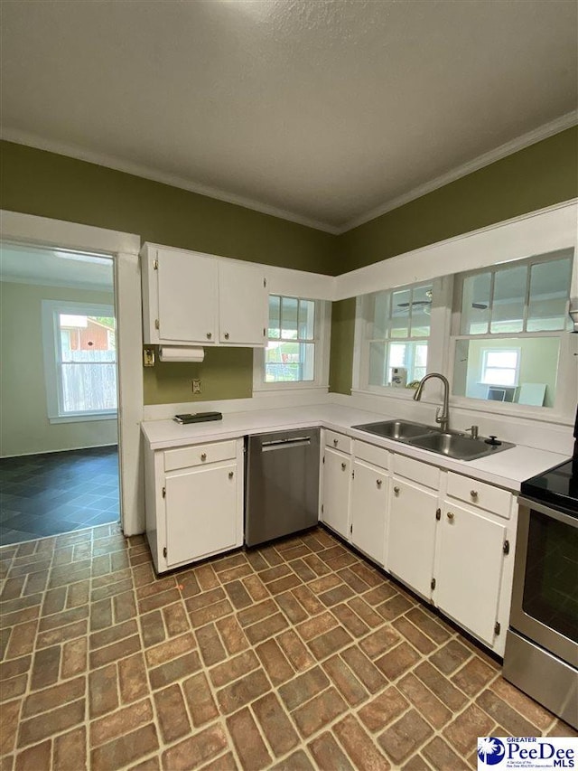 202 S Warley St, Darlington, SC 29532 - kitchen featuring a sink, stainless steel appliances, brick patterned flooring, light countertops, and white cabinetry