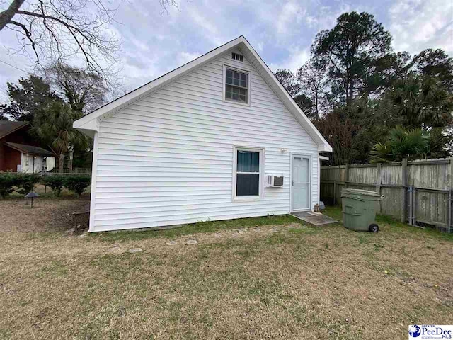 back of property with fence and a yard