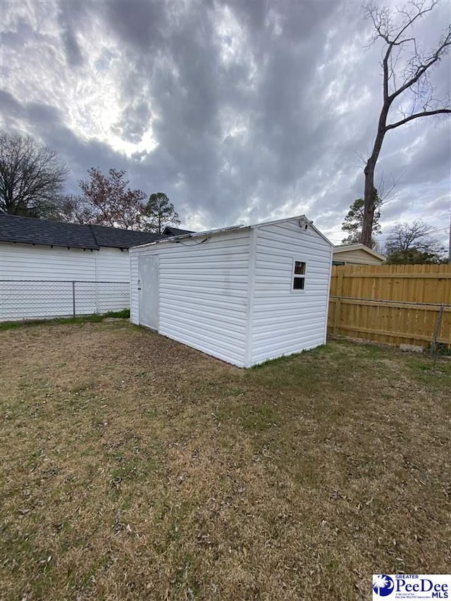 view of shed with fence