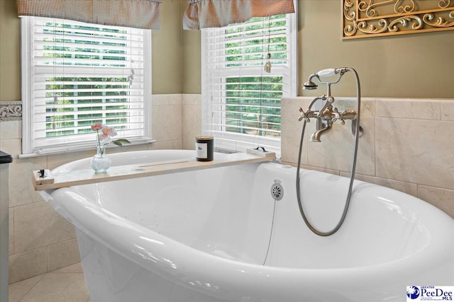3402 Sussex Ct, Florence, SC 29501 - full bath featuring tile walls, healthy amount of natural light, a jetted tub, wainscoting, and tile patterned flooring