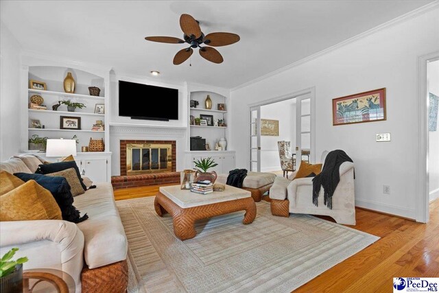 3402 Sussex Ct, Florence, SC 29501 - living area featuring a ceiling fan, light wood-type flooring, built in features, a fireplace, and ornamental molding