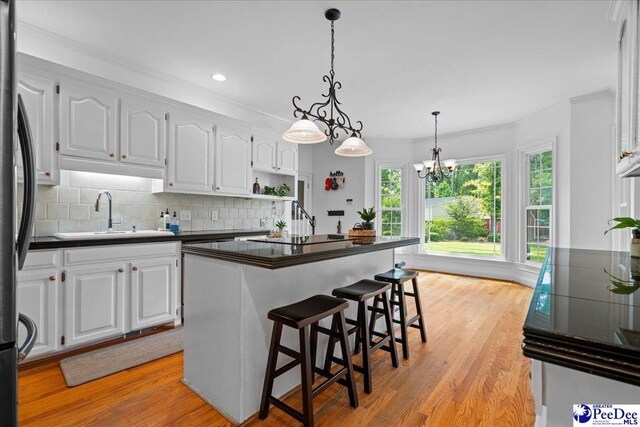 3402 Sussex Ct, Florence, SC 29501 - kitchen featuring dark countertops, white cabinetry, freestanding refrigerator, backsplash, and recessed lighting
