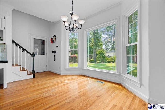 3402 Sussex Ct, Florence, SC 29501 - unfurnished dining area featuring light wood finished floors, a chandelier, stairs, and ornamental molding