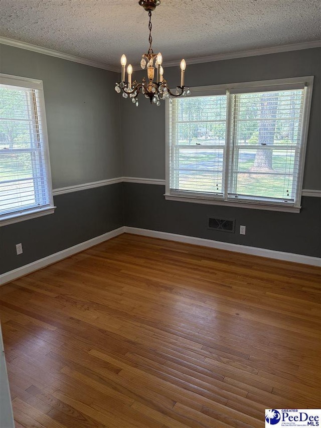 111 Brittain Rd, Darlington, SC 29532 - unfurnished room featuring a chandelier, wood finished floors, ornamental molding, a textured ceiling, and baseboards