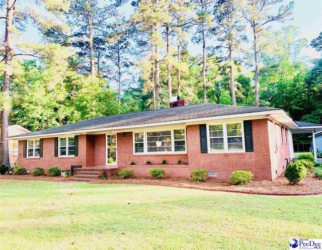 111 Brittain Rd, Darlington, SC 29532 - ranch-style house featuring brick siding, a front yard, crawl space, a chimney, and view of wooded area