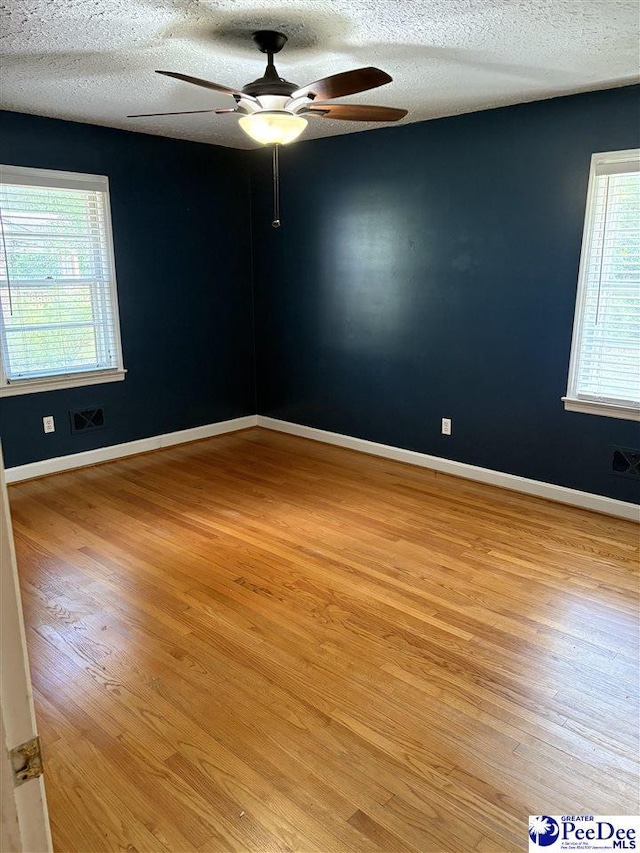 111 Brittain Rd, Darlington, SC 29532 - empty room featuring ceiling fan, light wood finished floors, a textured ceiling, and baseboards