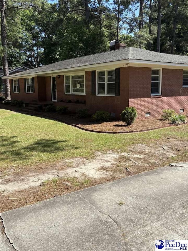 111 Brittain Rd, Darlington, SC 29532 - ranch-style house featuring crawl space, brick siding, a front yard, roof with shingles, and a chimney