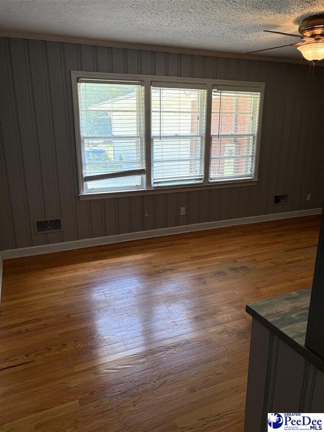 111 Brittain Rd, Darlington, SC 29532 - empty room with wood finished floors, baseboards, a ceiling fan, and a textured ceiling