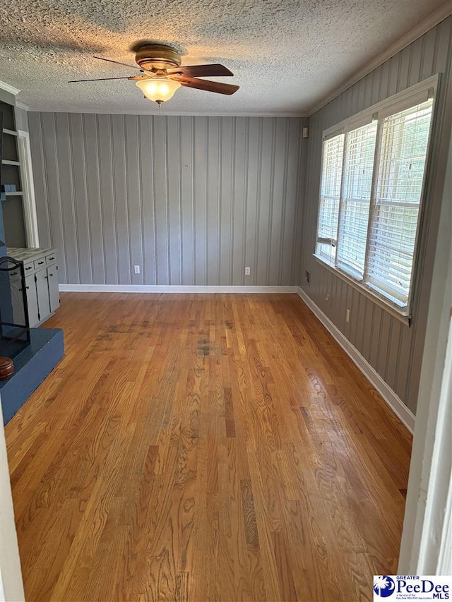 111 Brittain Rd, Darlington, SC 29532 - unfurnished living room with wood finished floors, a ceiling fan, baseboards, and a textured ceiling