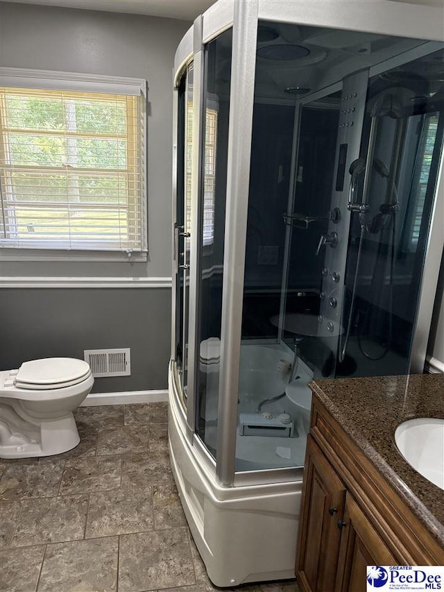 111 Brittain Rd, Darlington, SC 29532 - bathroom featuring toilet, vanity, a shower stall, baseboards, and stone finish flooring