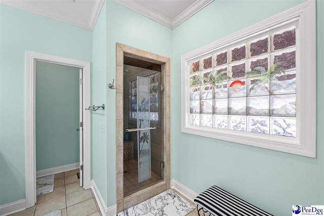 full bath featuring ornamental molding, a stall shower, tile patterned flooring, and baseboards